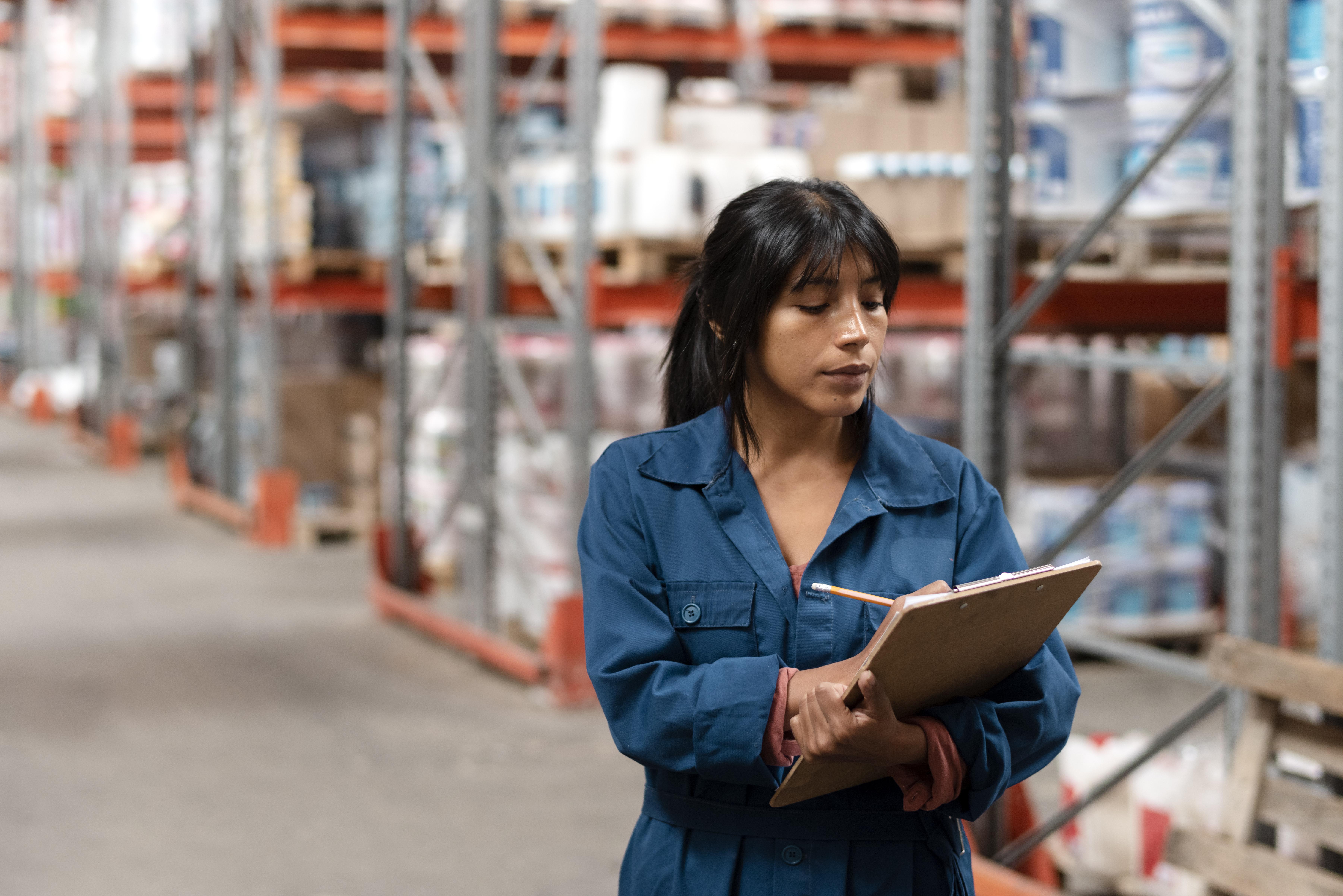 woman-worker-taking-notes-warehouse